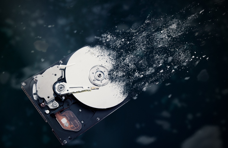 A hard drive disintegrating into dust