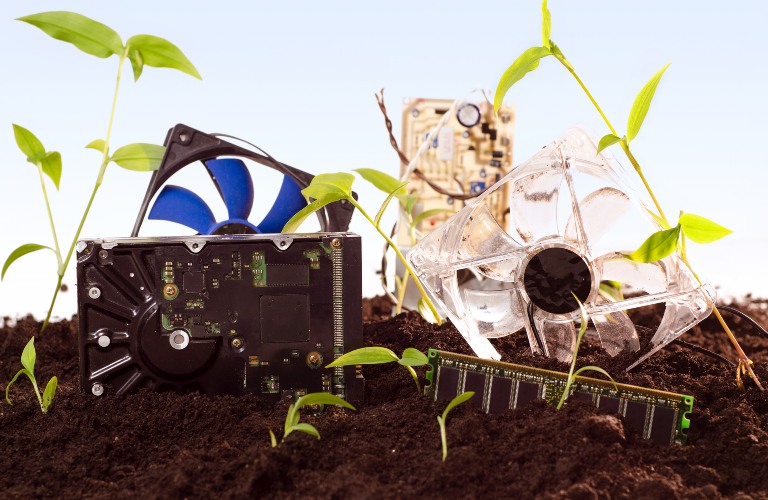 Electronics in a dirt field with plants