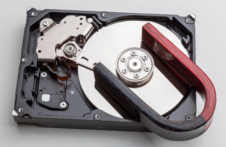 Magnet resting on a hard disk drive