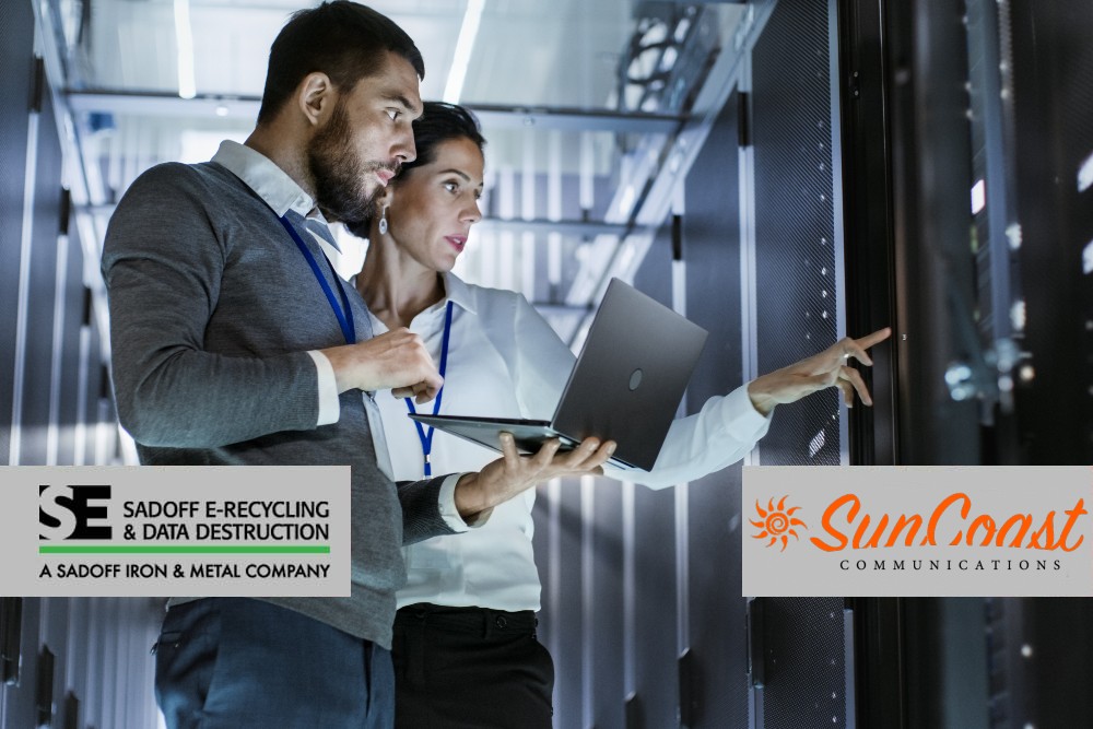 Man and woman looking at a server with Sadoff and SunCoast logos