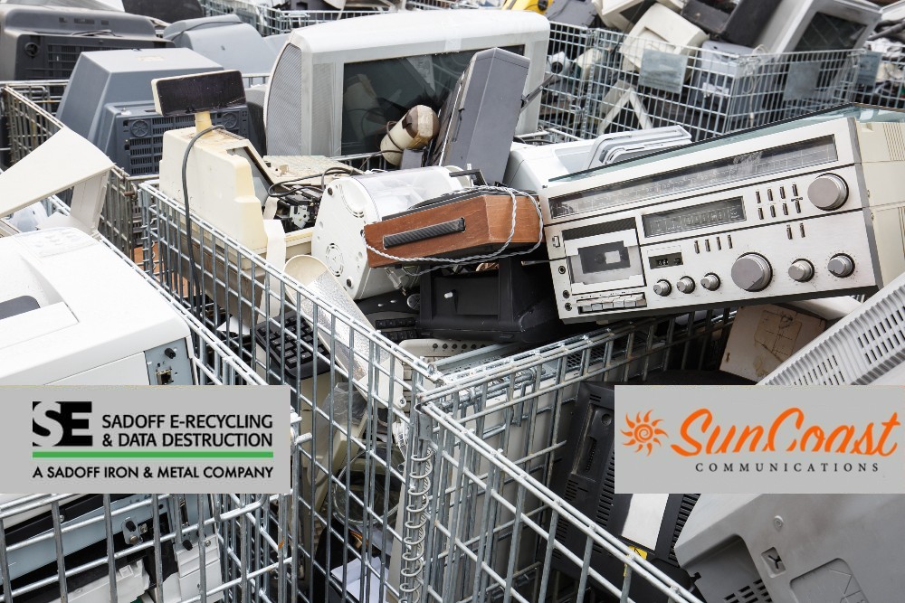 A bunch of e-waste in crates with Sadoff +SunCoast logo