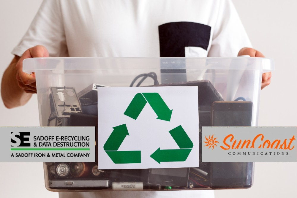 Man holding e-recyclables with Sadoff +SunCoast logo