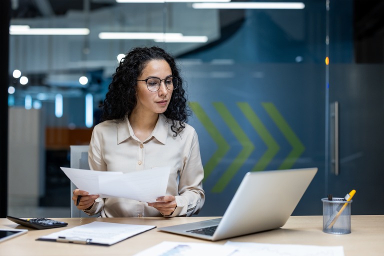 Woman reviewing IT assets and documents