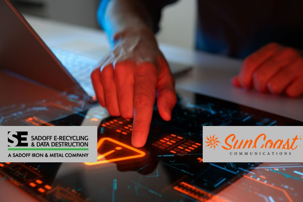 Man touching excalmation point on a digital intercface with Sadoff and SunCoast Logos