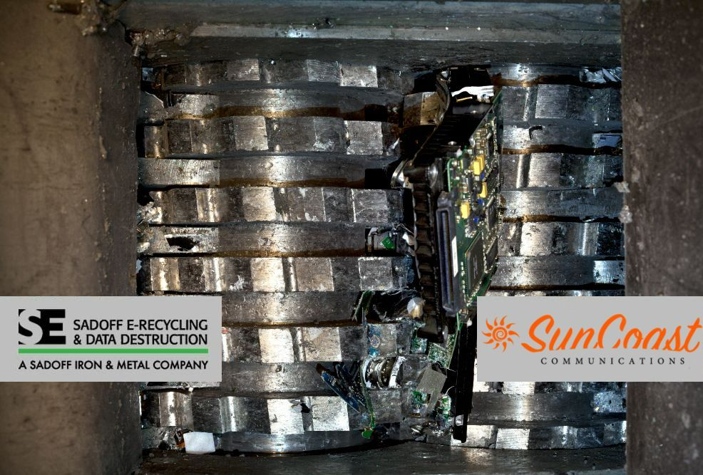 Hard drive in a shreder with the Sadoff and SunCoast logos