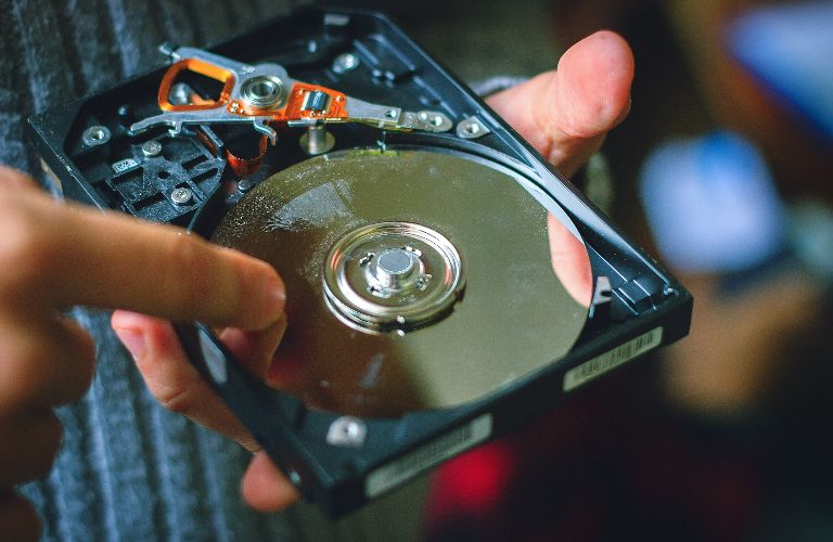 man pointing to a single hard drive