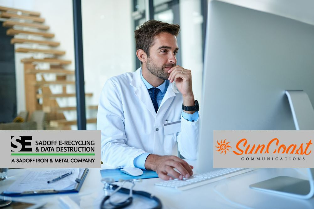 Doctor looking at a computer screen Sadoff and SunCoast logos