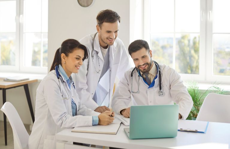 Doctors looking at a new computer